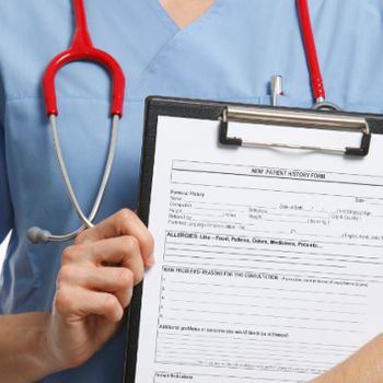 Medical Assistant Holding Forms